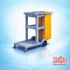 A professional janitorial cleaning cart in blue with an integrated waste bag and storage shelves